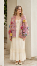 Model wearing pink chunky knit floral cardigan from the front