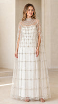 Front view of model wearing Ivory White high neck beaded cape evening gown