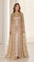 Front view of model wearing floor-length champagne gold beaded evening cape gown