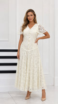 Full-length front view of cream floral lace maxi dress with capelet sleeves and button front