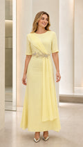 Full front view of model wearing pastel yellow short sleeve maxi formal dress with beaded waist