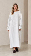 Front view of woman wearing oversized light grey ribbed knit maxi dress
