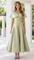 Front view of woman wearing sage green capelet V-neck A-line midi dress