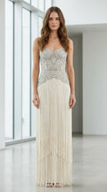 Front view of champagne beaded strapless fringe evening gown