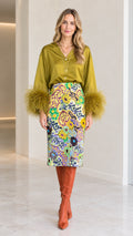 Olive green satin blouse with feather cuffs paired with floral midi skirt