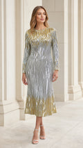 Front view of woman wearing silver and gold sequin chevron long sleeve midi dress