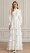 Full front view of model wearing white tiered lace high neck maxi dress with pearl accents