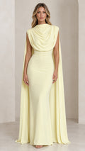 Front view of model wearing the butter yellow draped cowl neck cape maxi gown