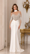 Front view of woman wearing white long sleeve pearl-embellished illusion evening gown