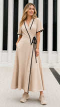 Front view of model wearing Beige short sleeve wrap maxi dress with black contrast trim