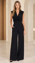 Front view of model wearing a black cowl neck sleeveless wide leg jumpsuit