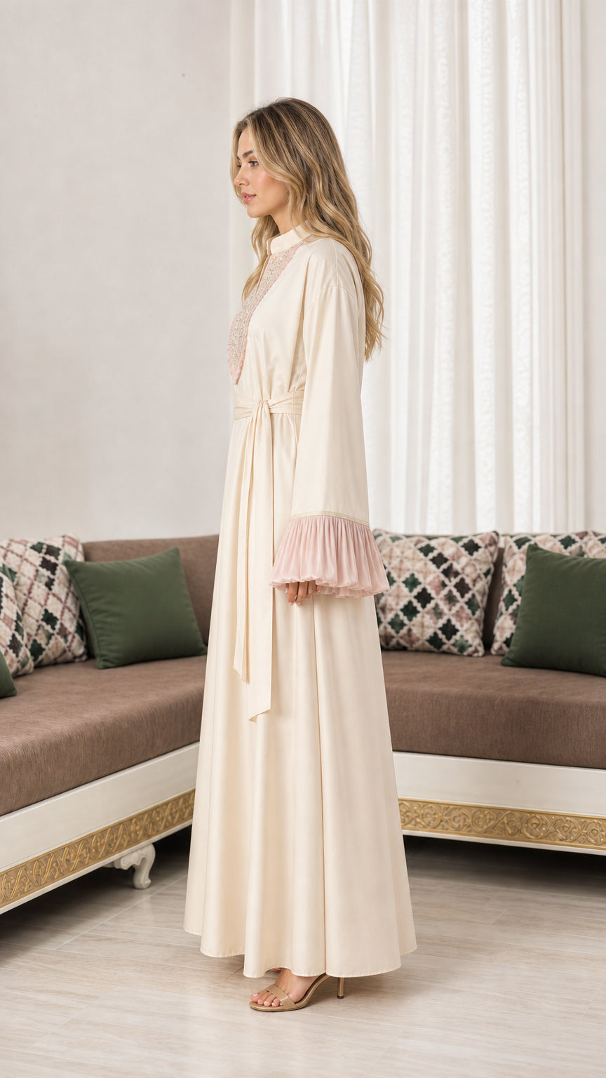 Side profile view of woman wearing cream belted maxi dress with ruffled bell sleeves