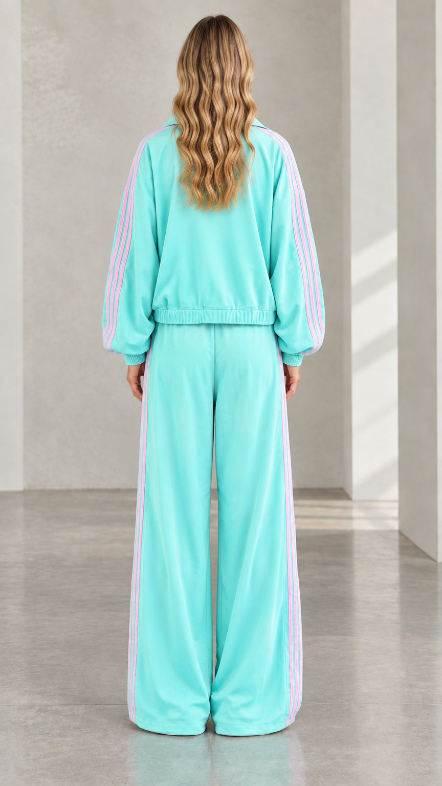 Back view of model wearing mint green zip jacket and wide leg pants set