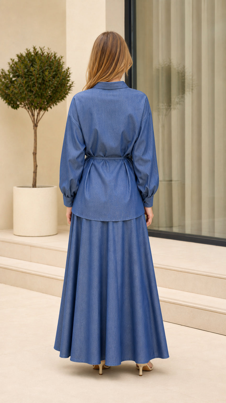 Back view of woman wearing Denim Blue two-piece shirt and maxi skirt set