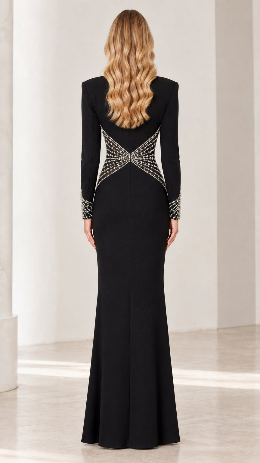Back view of black long sleeve gown showing crystal starburst waist design
