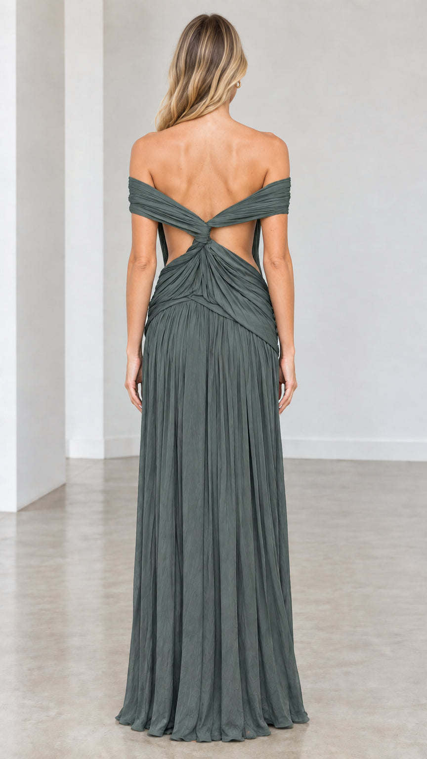 Back view of Sage Green dress highlighting open back and twisted draping
