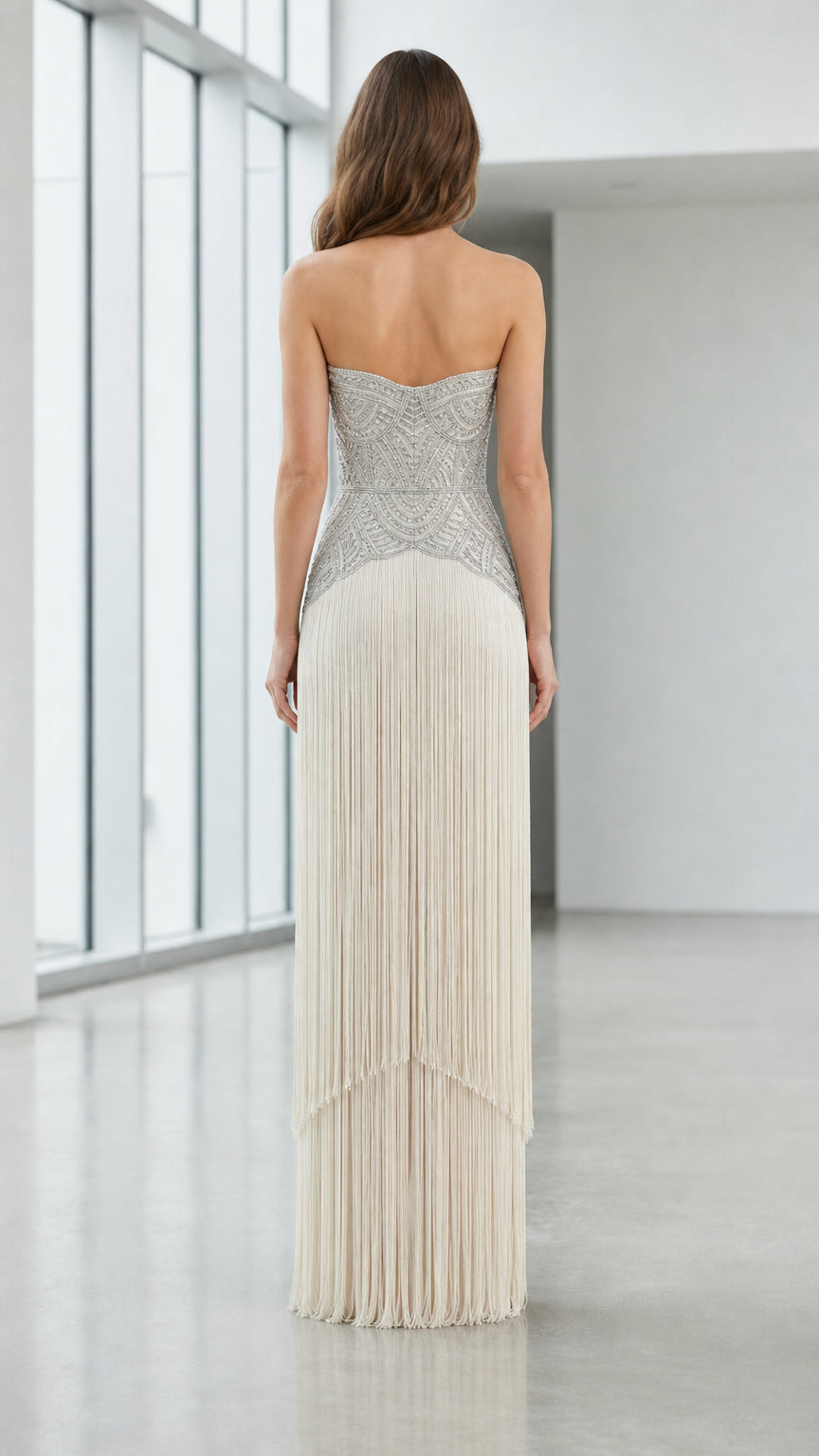 Back view of champagne strapless fringe gown