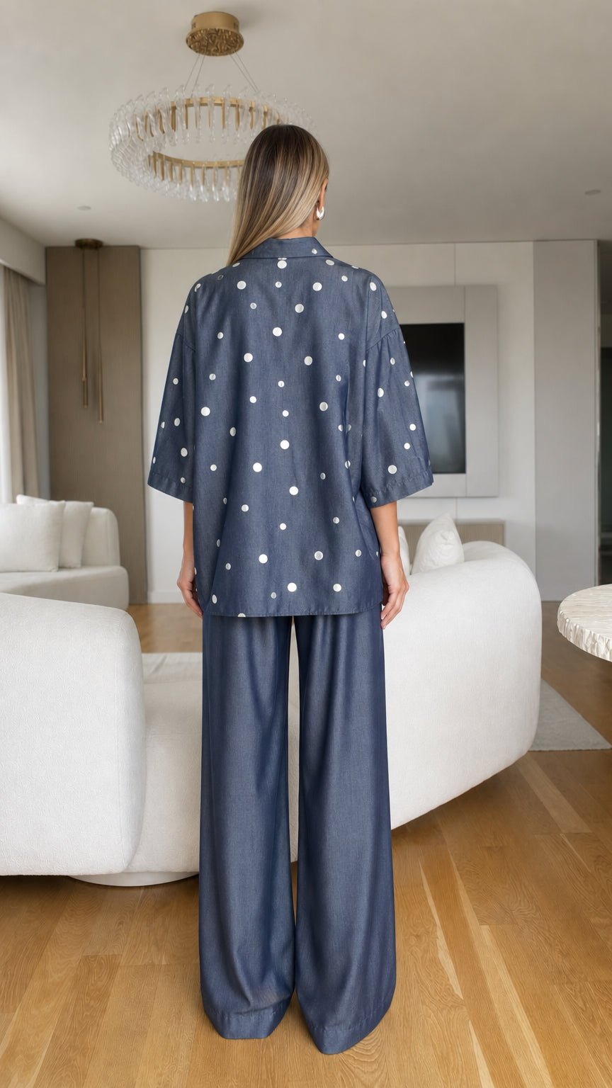 Model wearing denim blue polka dot co-ord set back view