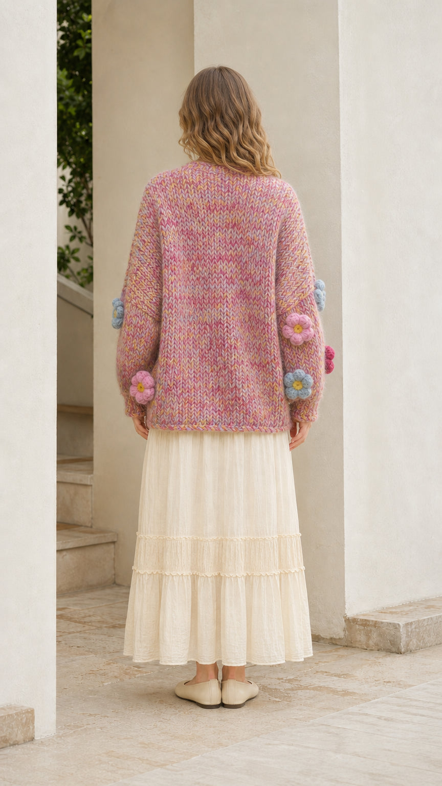 Model wearing pink floral cardigan from the back