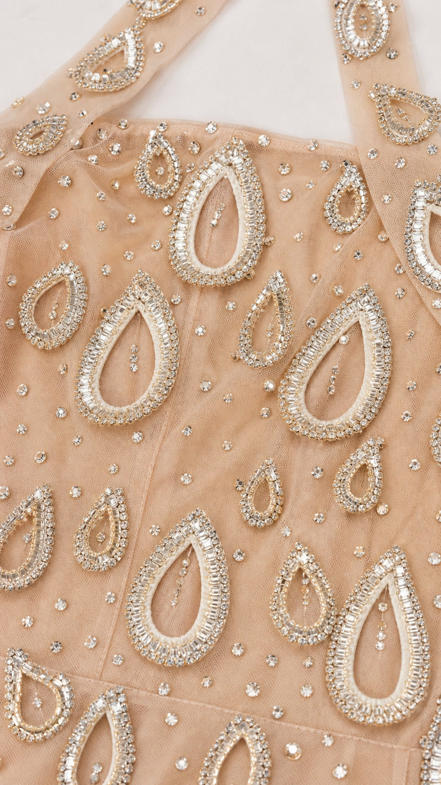 Close-up detail of teardrop rhinestone beading and mesh fabric