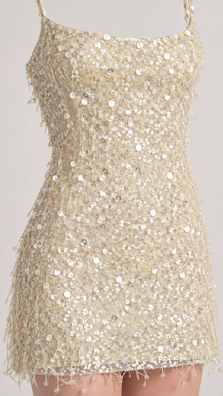 Close-up detail of shimmering sequins and delicate fringe trim