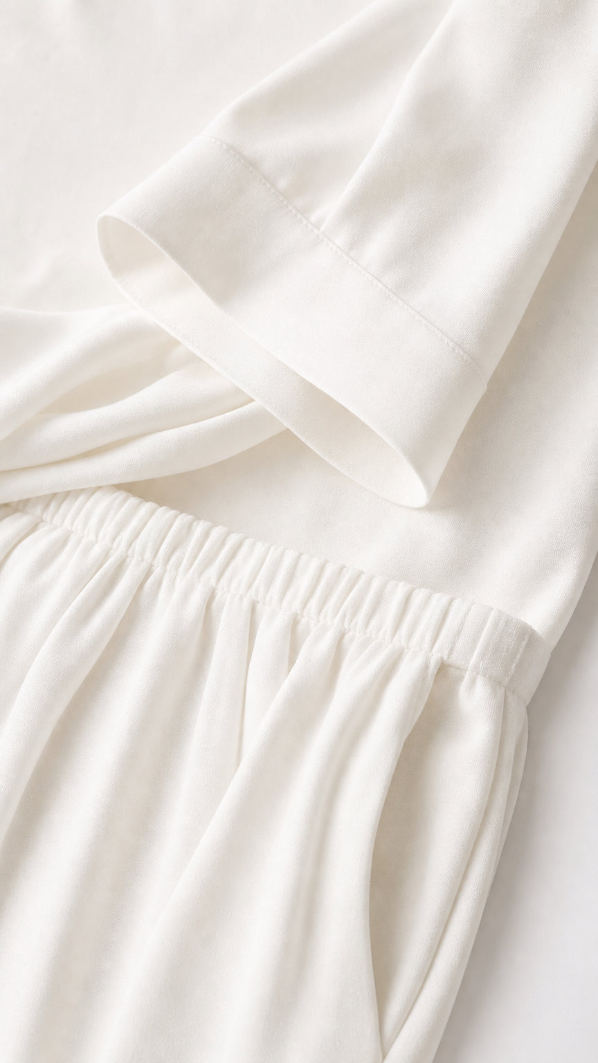 Close-up detail of white top cuff and elastic waistband