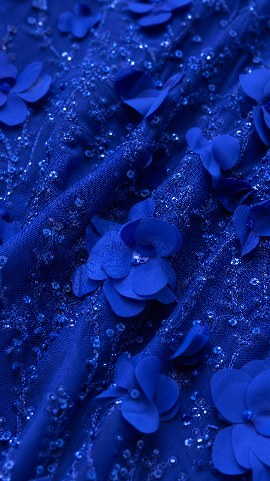 Close-up detail of royal blue 3D floral applique and beaded embroidery