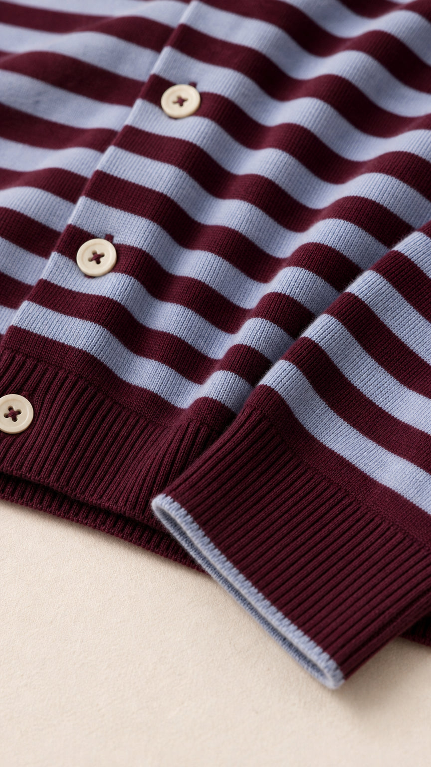 Close-up detail of buttons, striped pattern, and ribbed cuffs on the knit cardigan