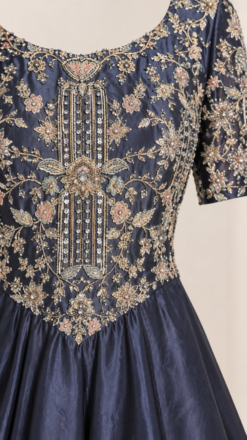 Close-up detail of intricate floral embroidery and beadwork on navy bodice